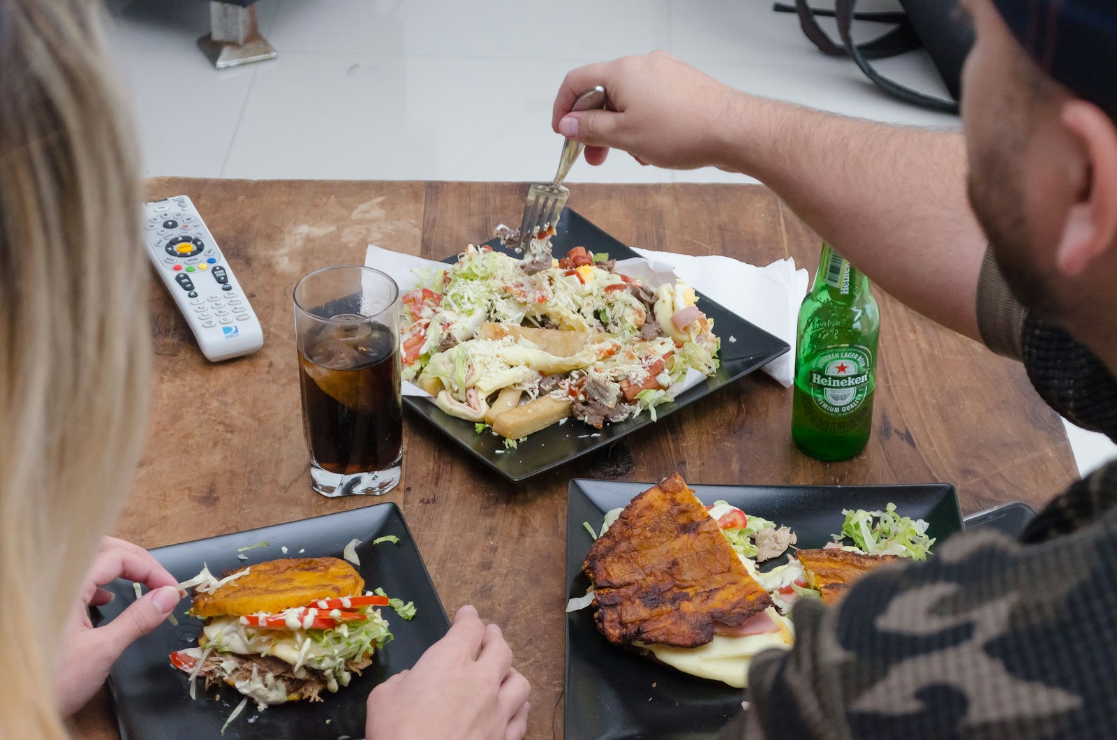 person holding fork and bread knife