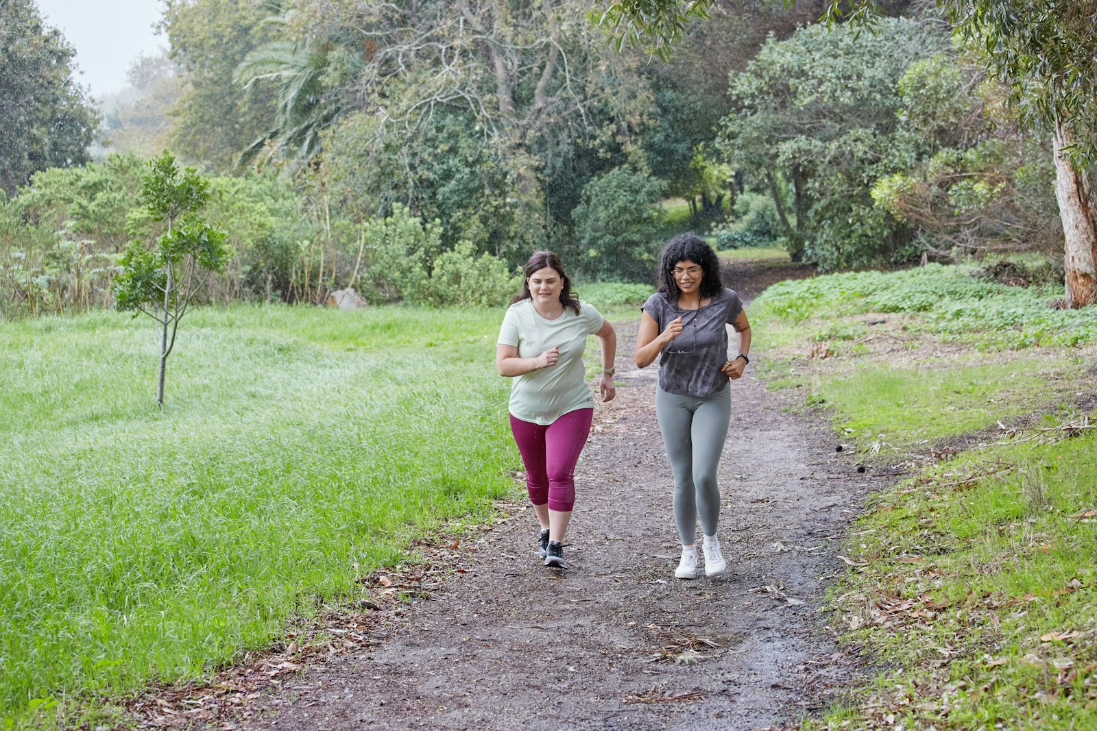 Two women are running together on a path.