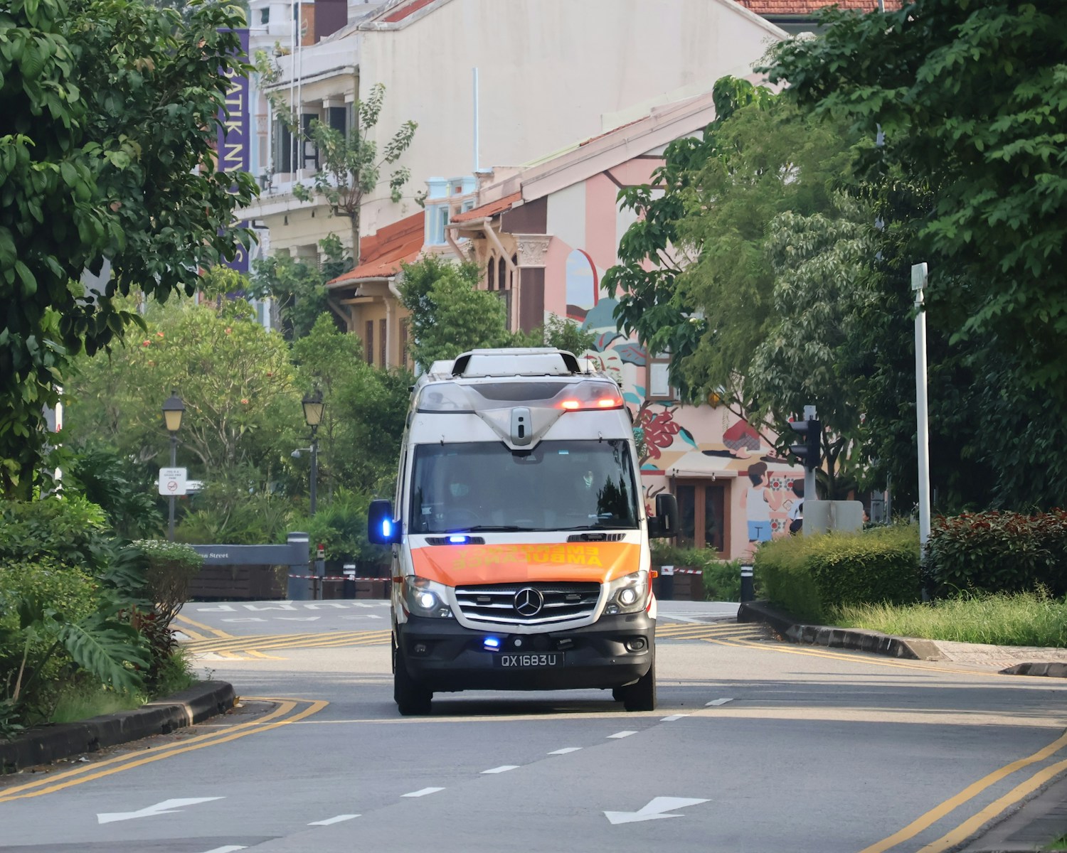 An ambulance is driving down the street.
