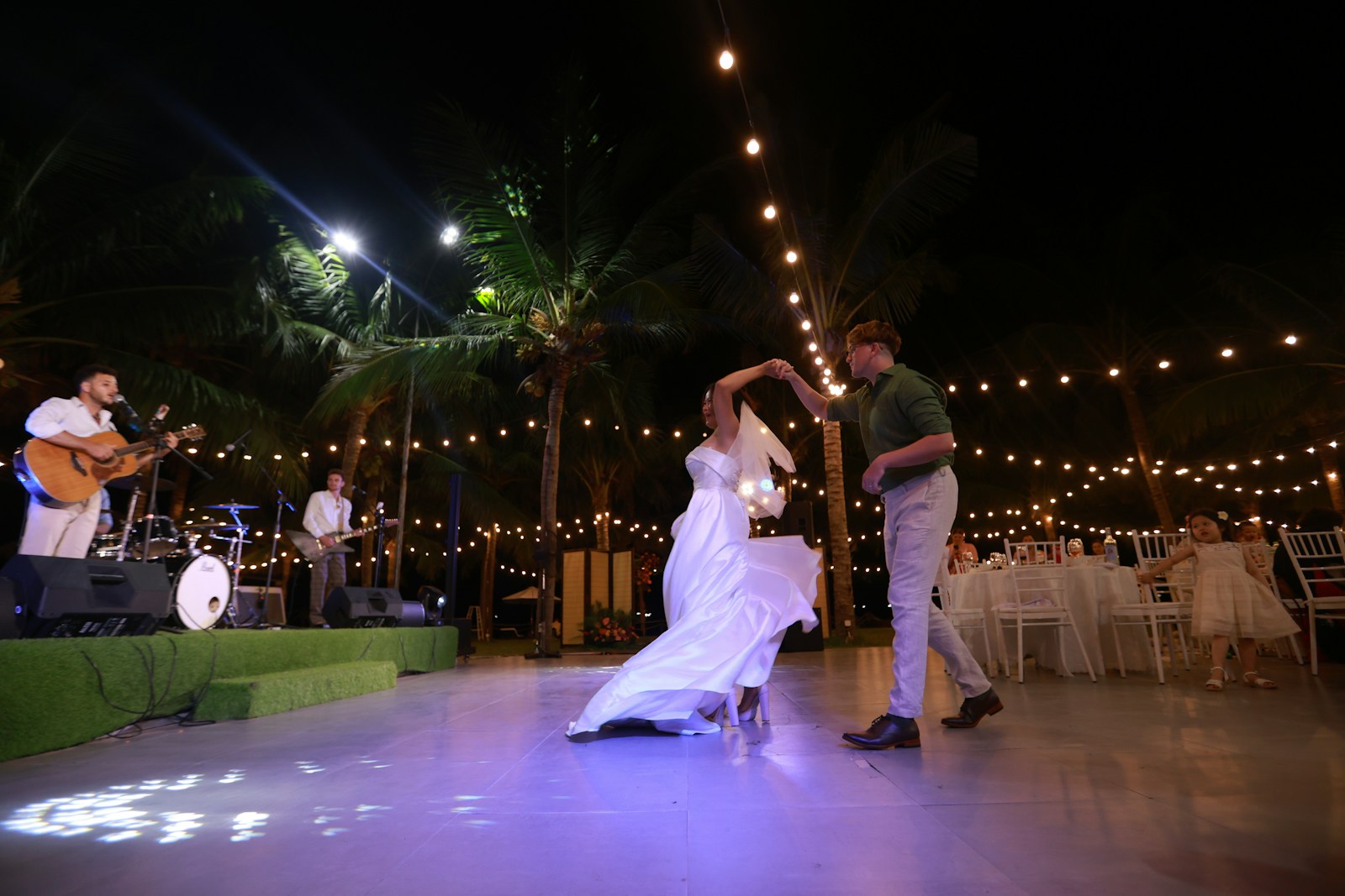 Couple dancing at a wedding reception with live band.