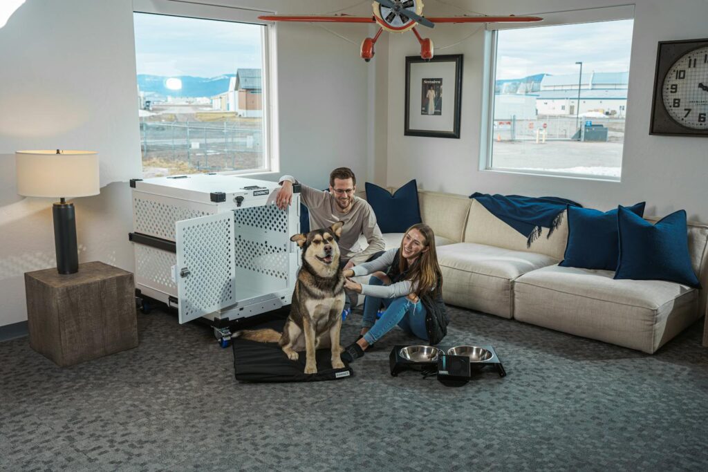 A joyful couple enjoys quality time with their trained dog in a contemporary living space.