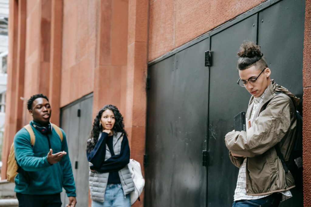 Group of diverse teenagers having a serious discussion in an urban outdoor setting.