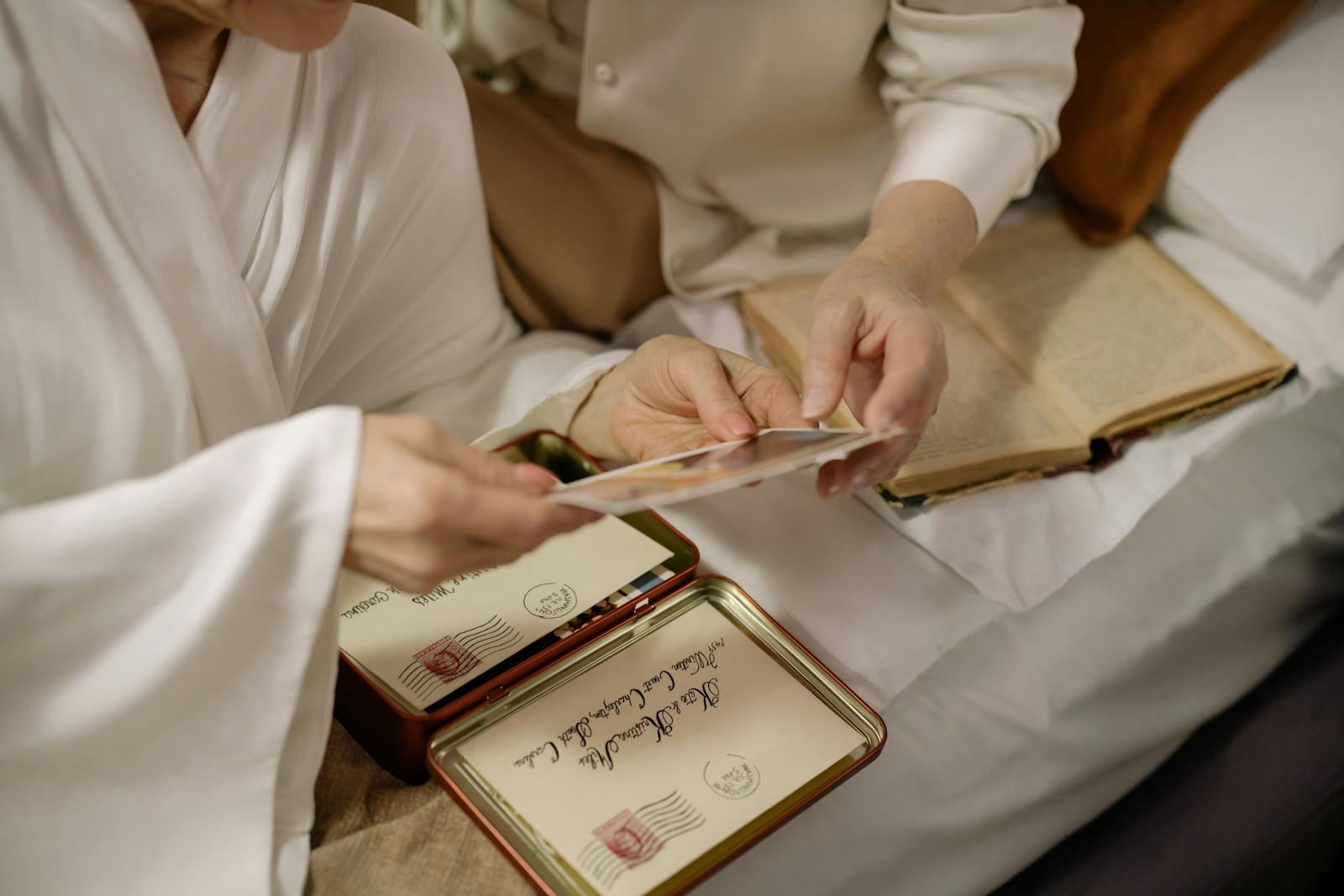 Two adults hold old photos, evoking nostalgia and timeless love.