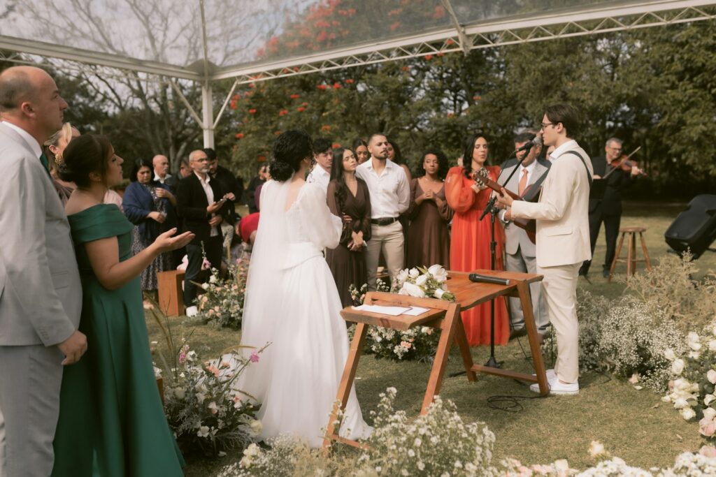 A wedding ceremony is taking place outdoors.