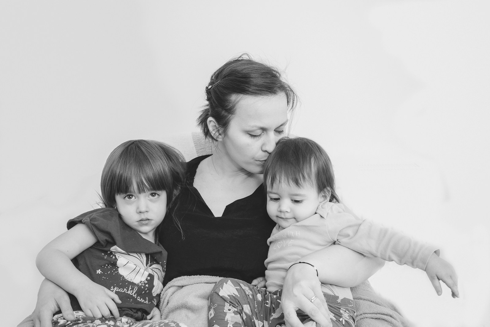 a little girl sitting on a bed