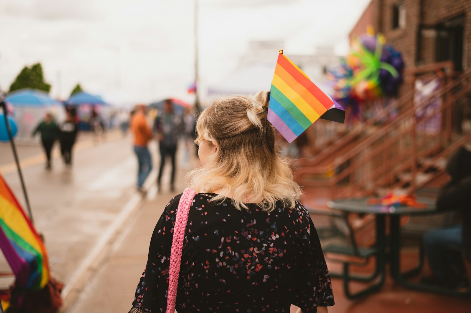 a woman with a rainbow hat on her head