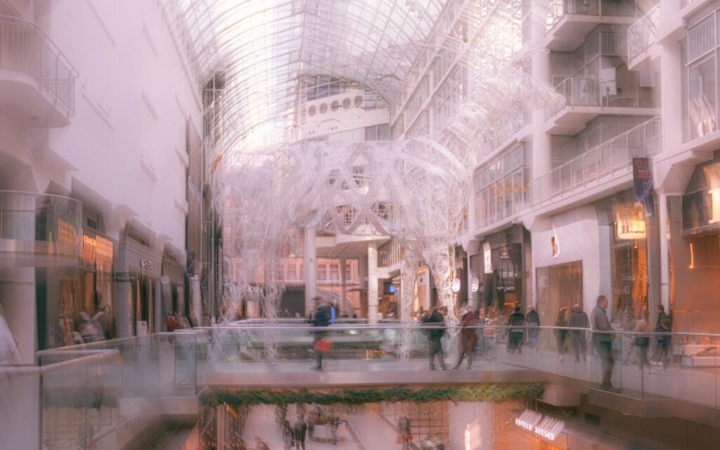Blurred view of a busy indoor shopping mall atrium