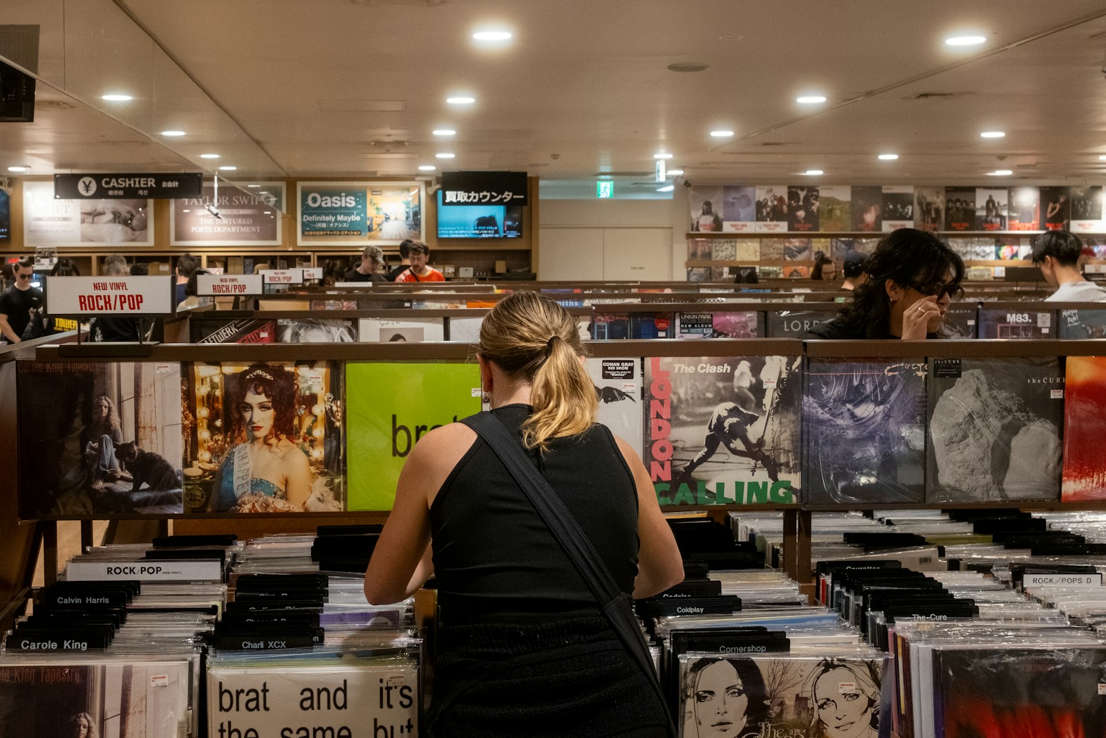 People browse vinyl records in a record store.