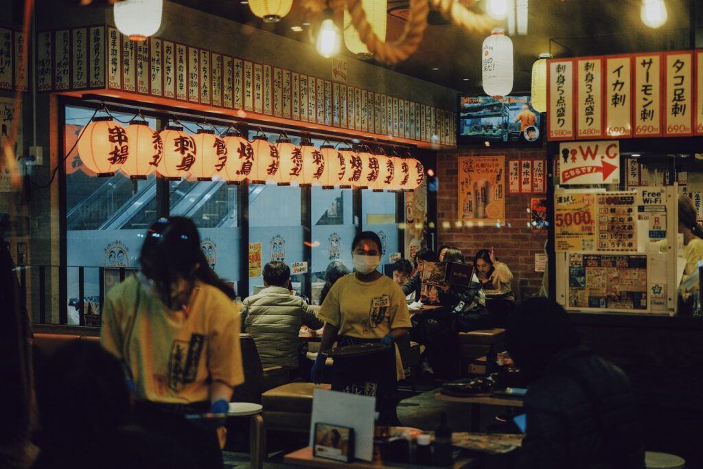 People dining in a japanese restaurant with lanterns