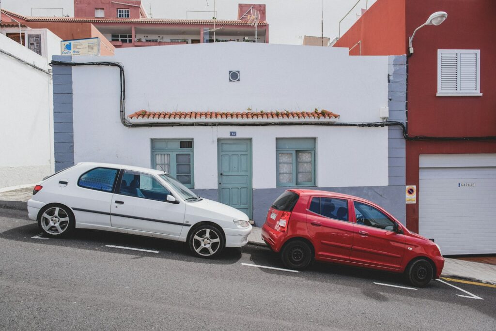 white and red 5-door hatchbacks on street