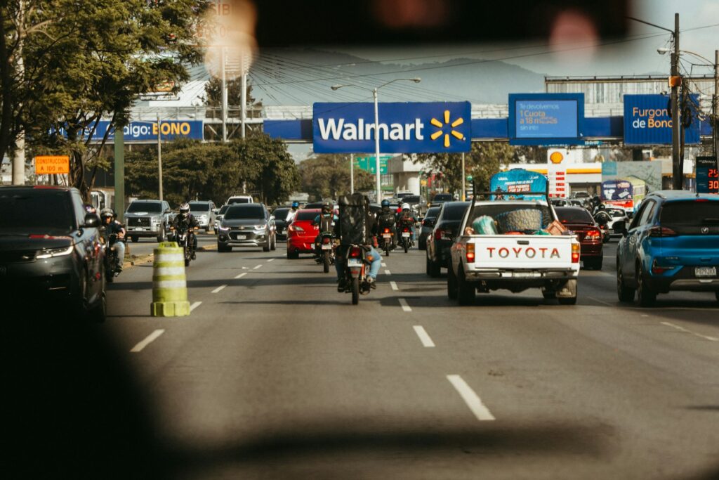 Busy road traffic passes a walmart store.