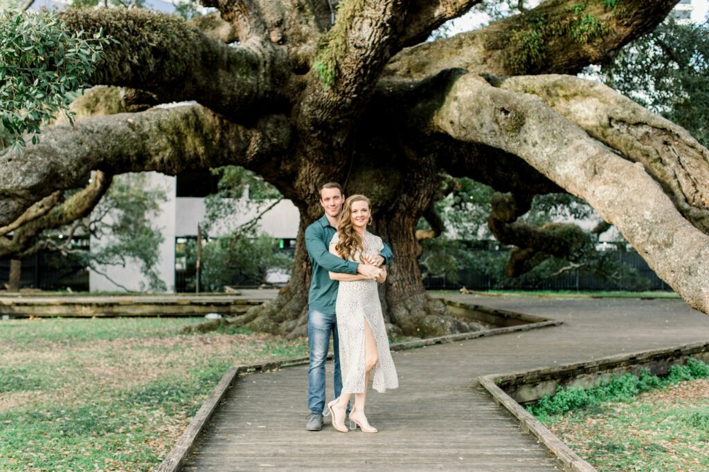 woman in blue dress standing on brown wooden bridge