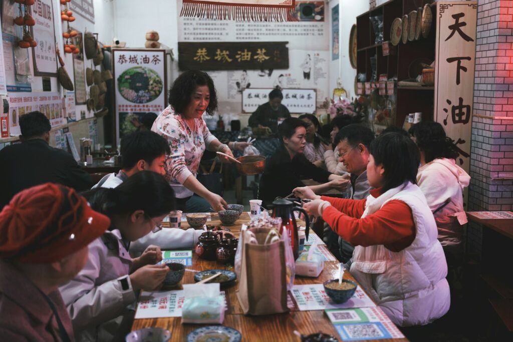 People dining in a busy, dimly lit restaurant.