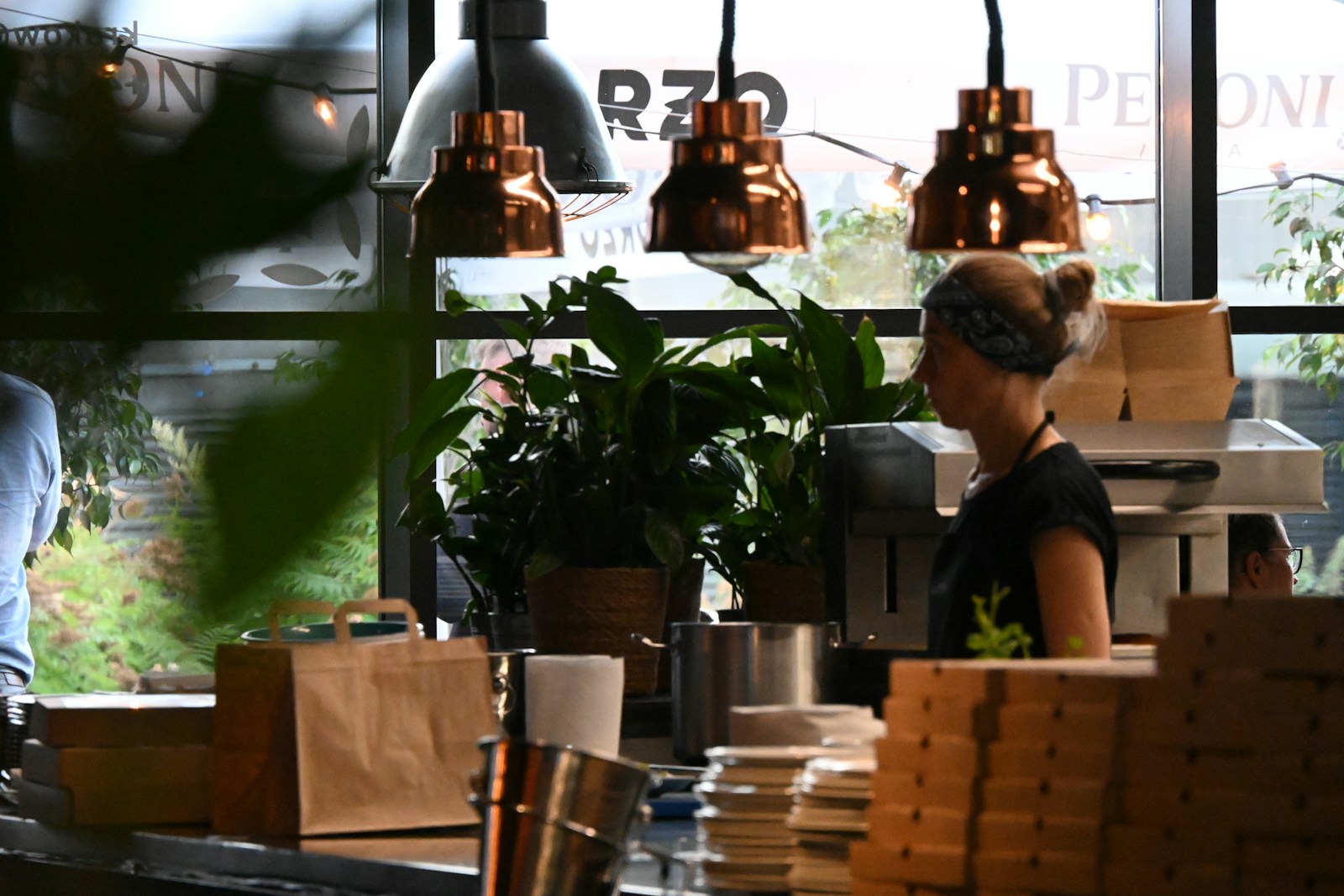 a woman standing behind a counter in a restaurant