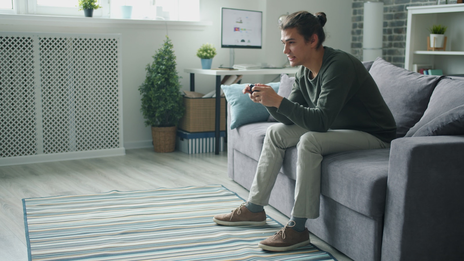 Man playing video games on couch