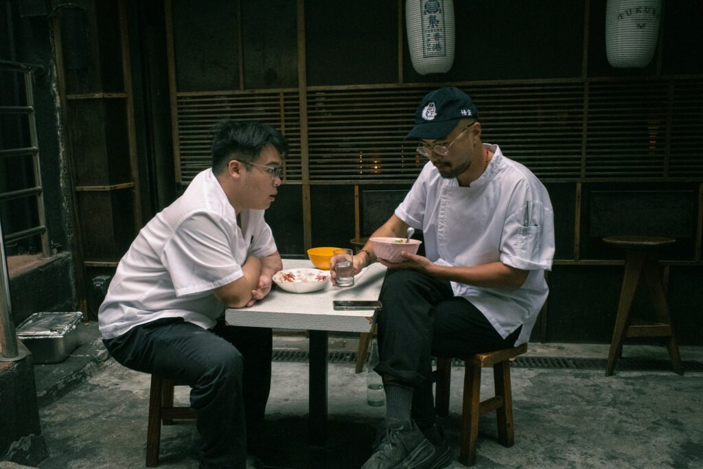 Two men sitting at a table talking