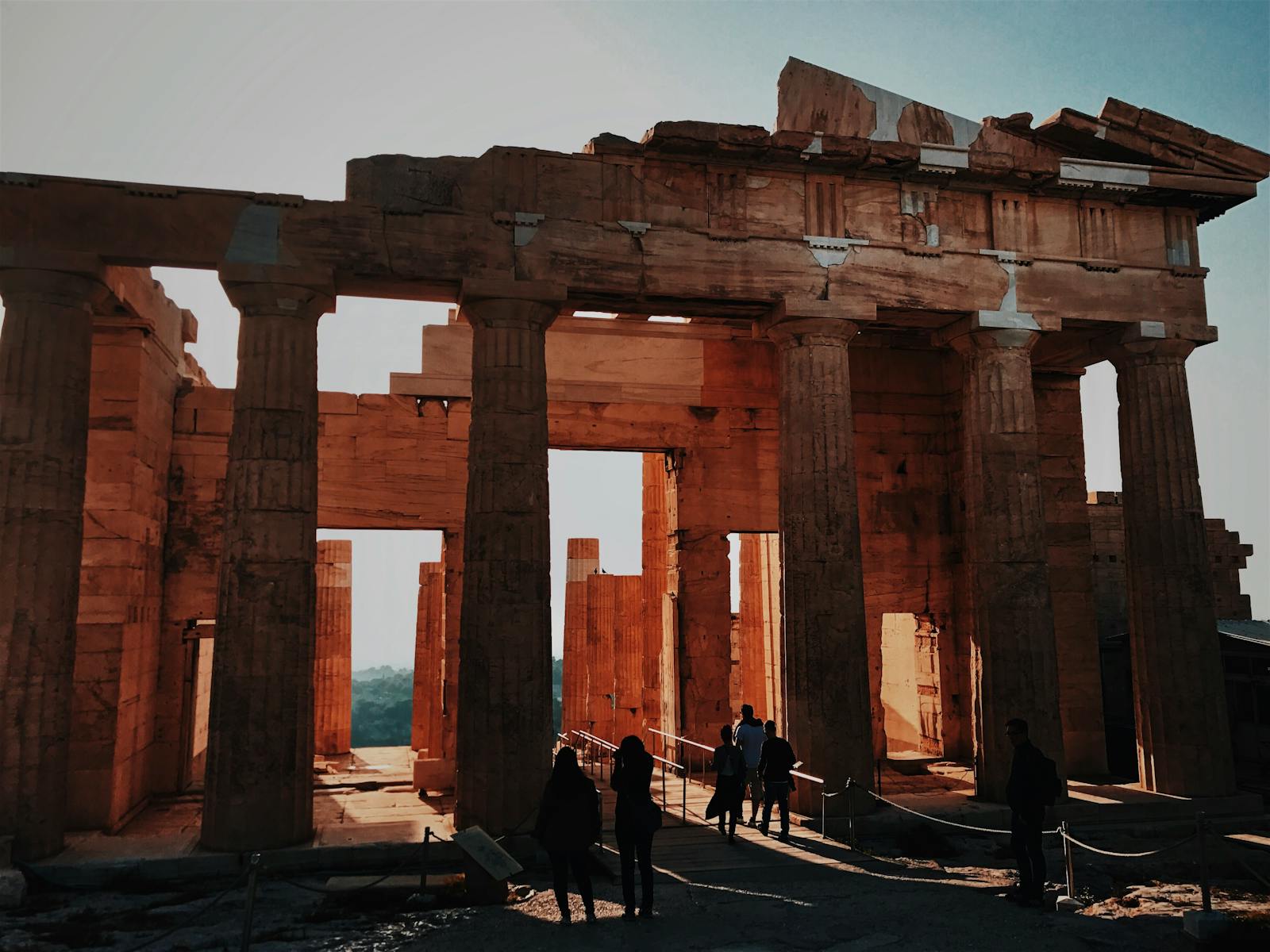 Discover the beauty of ancient architecture at sunset as tourists explore this iconic historic site.