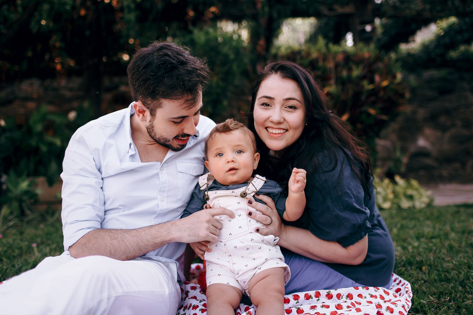 Young family with baby enjoying a sunny day outdoors, capturing joy and togetherness.
