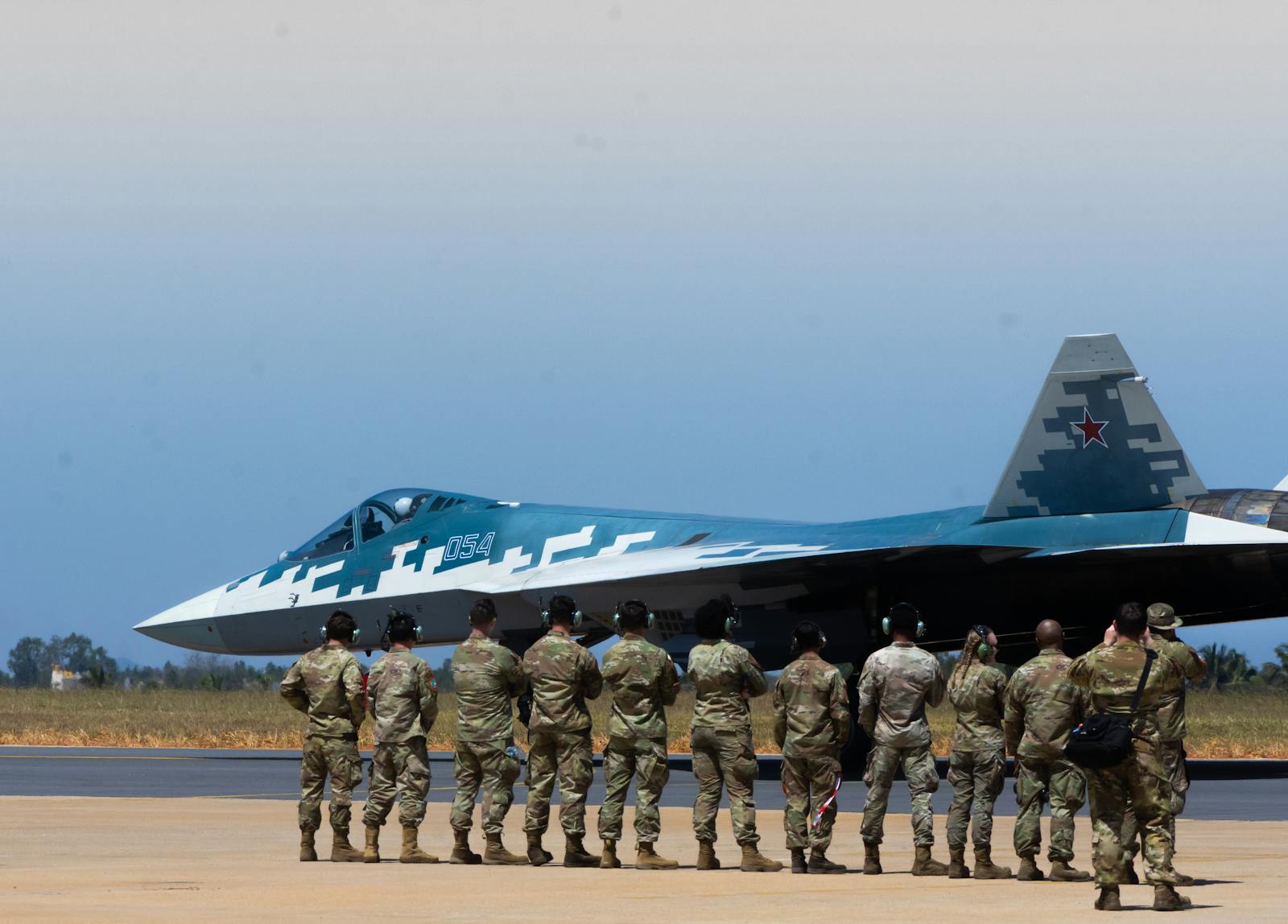 Group of soldiers observing a fighter jet at an airshow in Bengaluru, India.