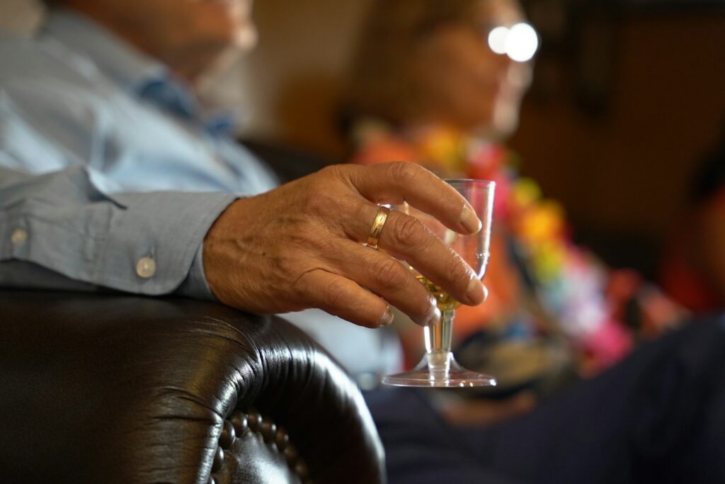 a man holding a wine glass in his hand