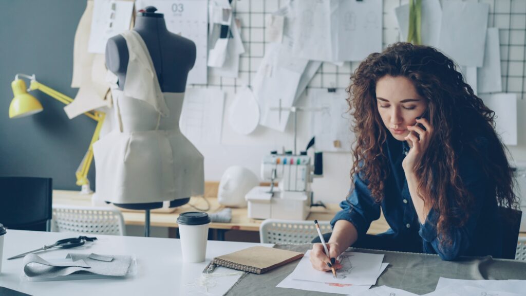 A designer works on notes in her studio.