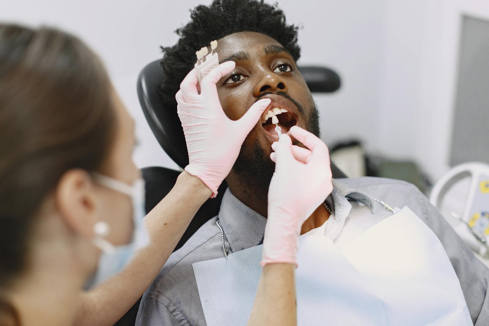 A patient receiving dental care during a checkup in a clinic.