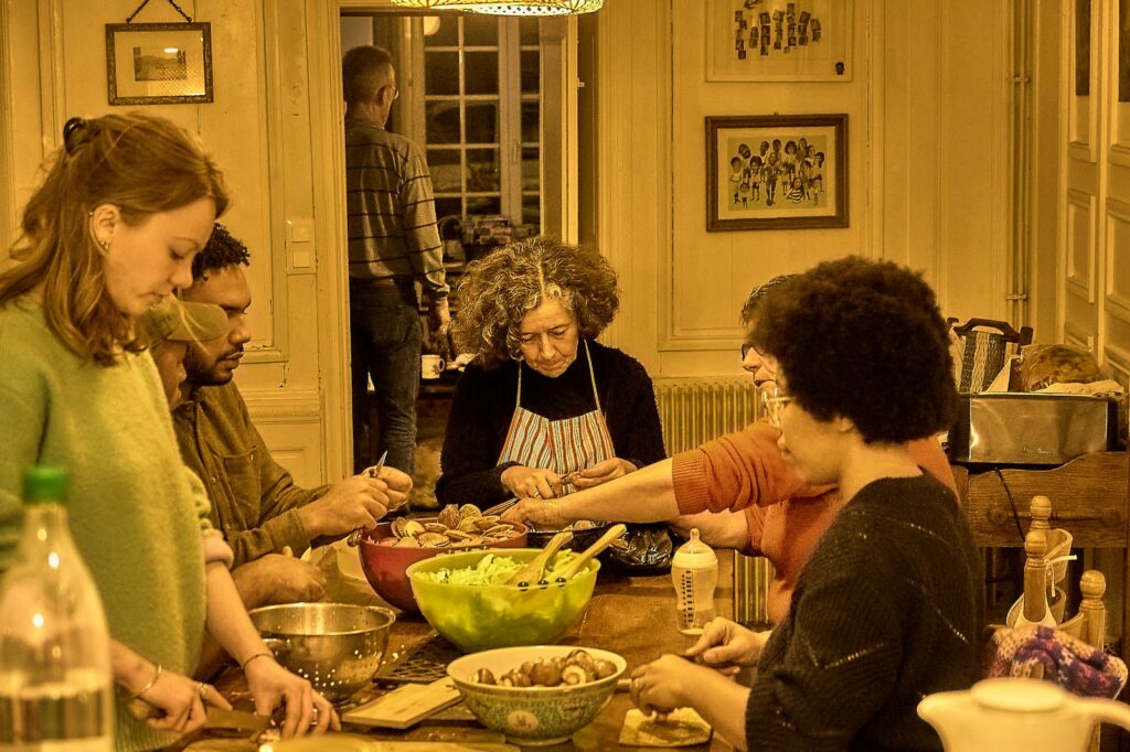 People gathered around a table preparing food together