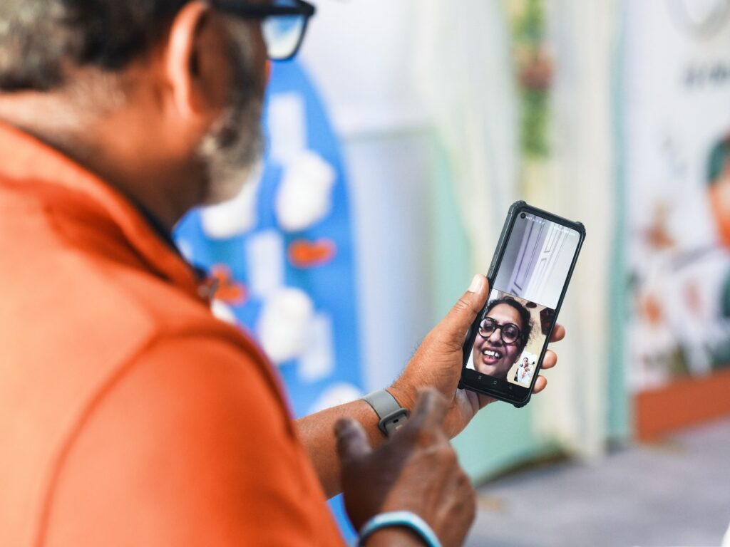 Man video calling with a smiling woman