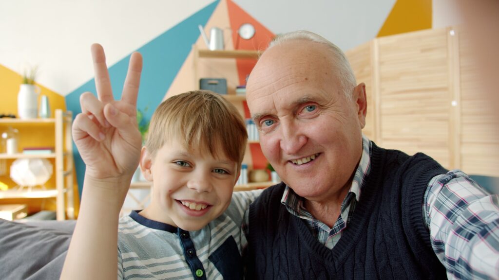 Grandfather and grandson making peace sign