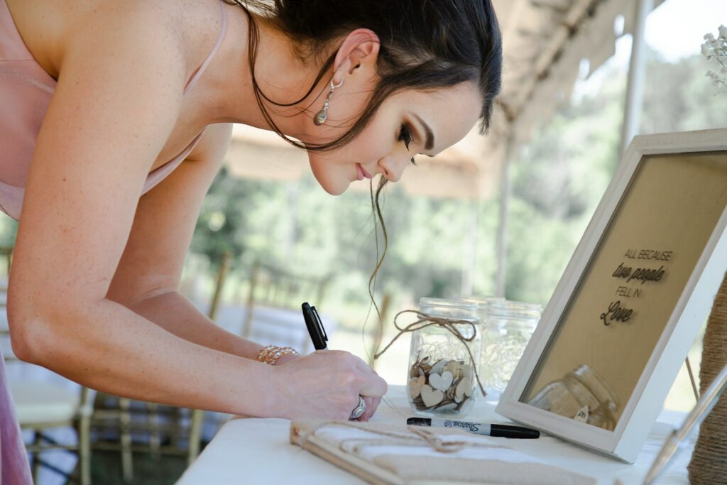 woman in white tank top writing on white paper
