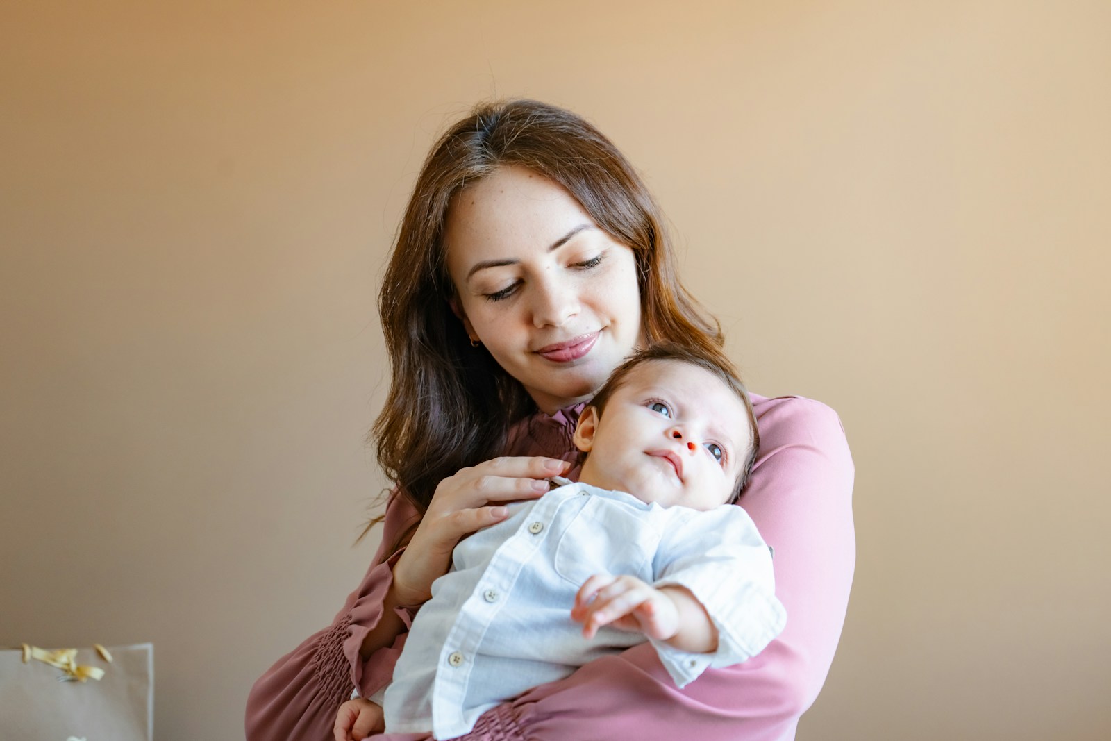 a woman holding a baby in her arms