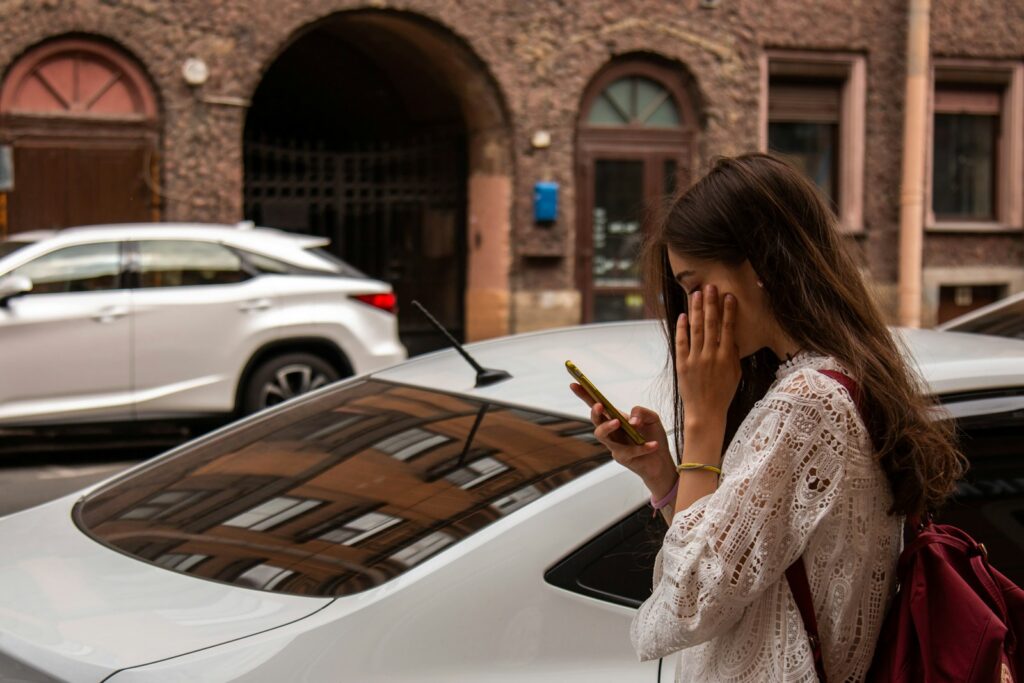 woman wearing white blouse beside white vehicle