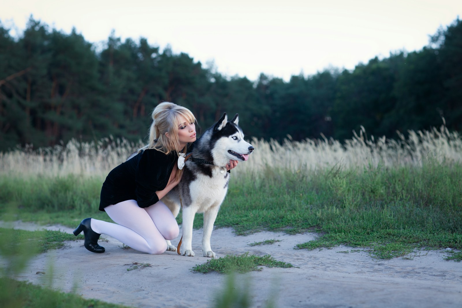 Woman in white tights with husky dog outdoors
