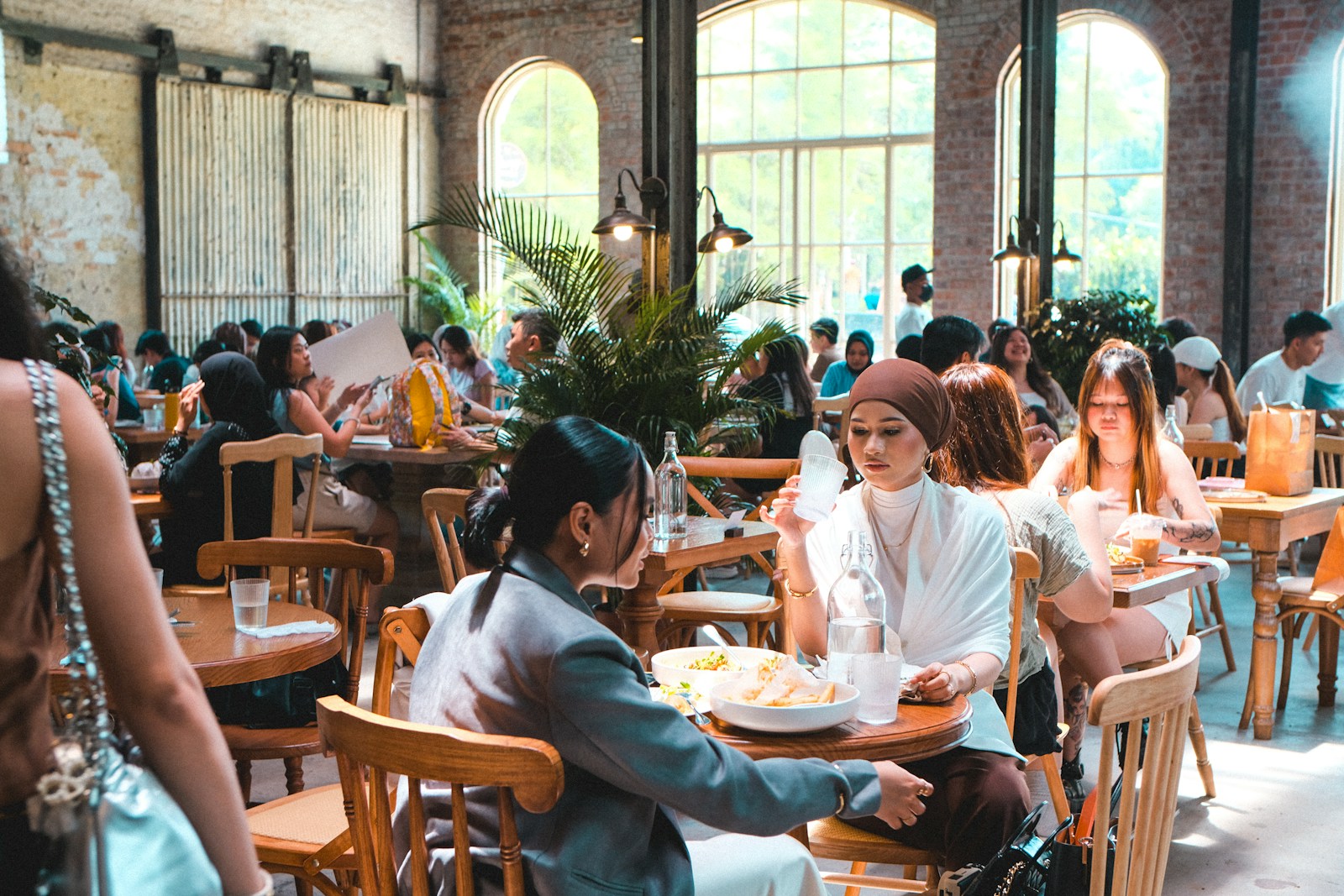 People are dining in a busy, stylish restaurant.