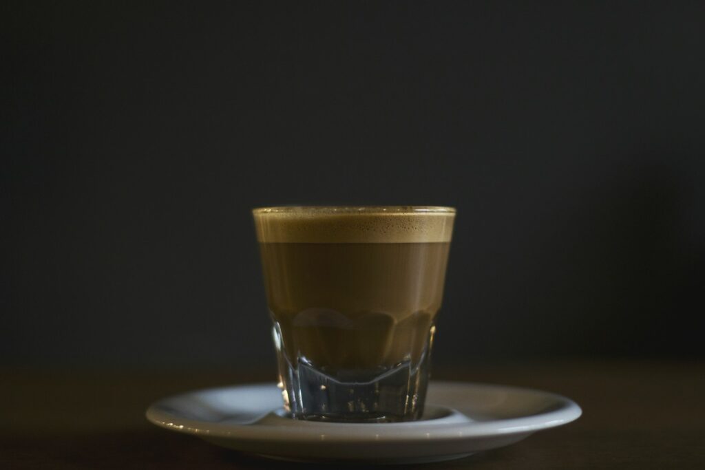 coffee filled rock glass on saucer