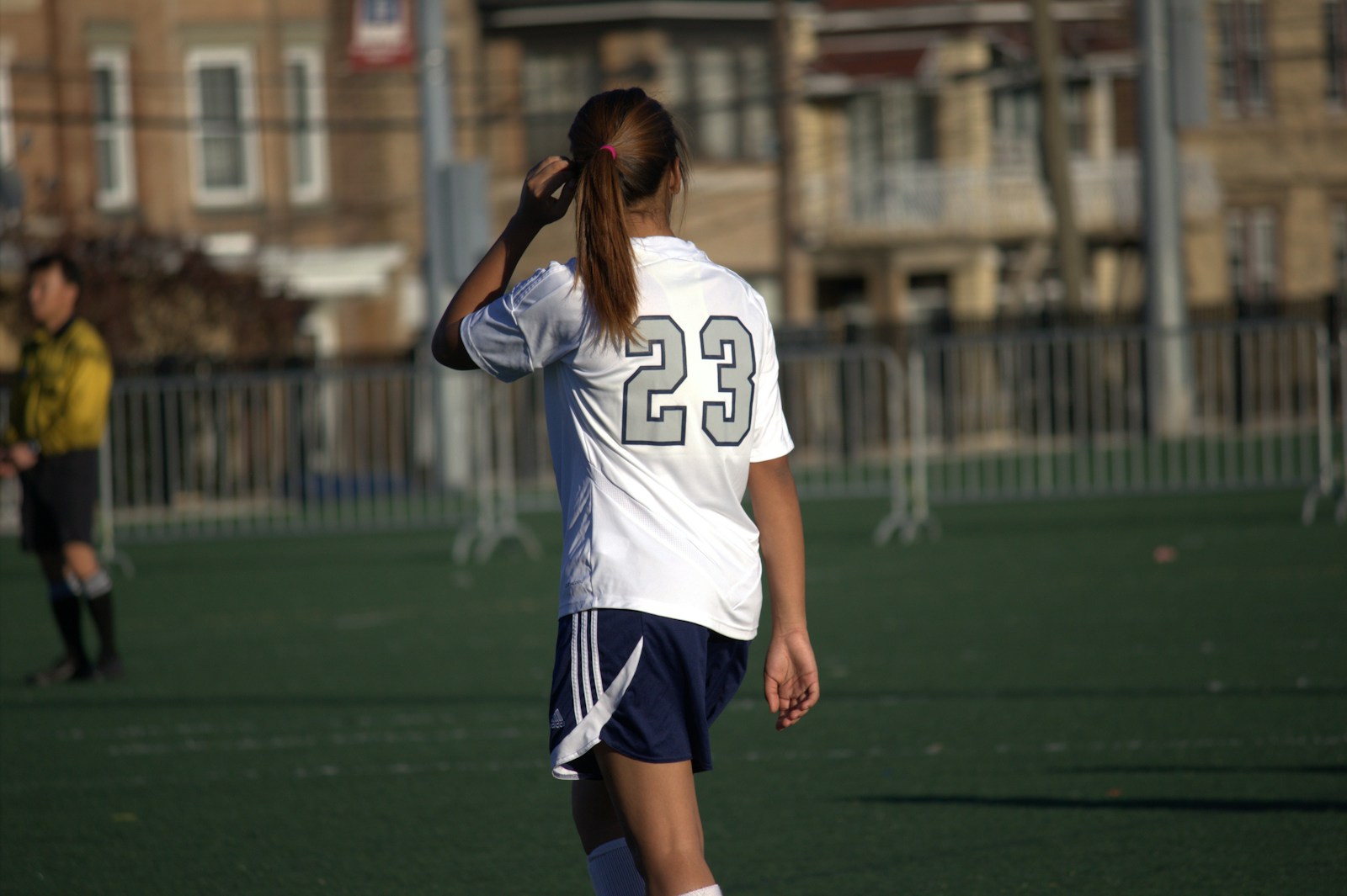 A woman standing on top of a soccer field