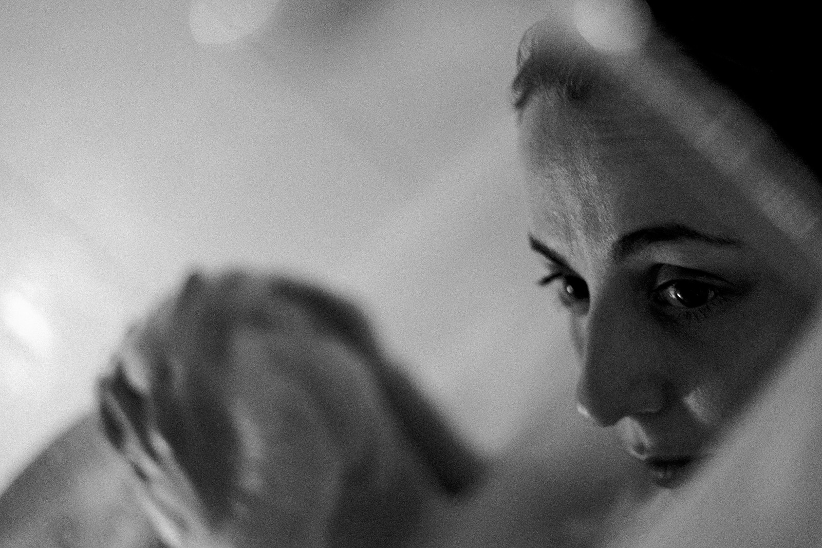 a woman looking at her reflection in a mirror