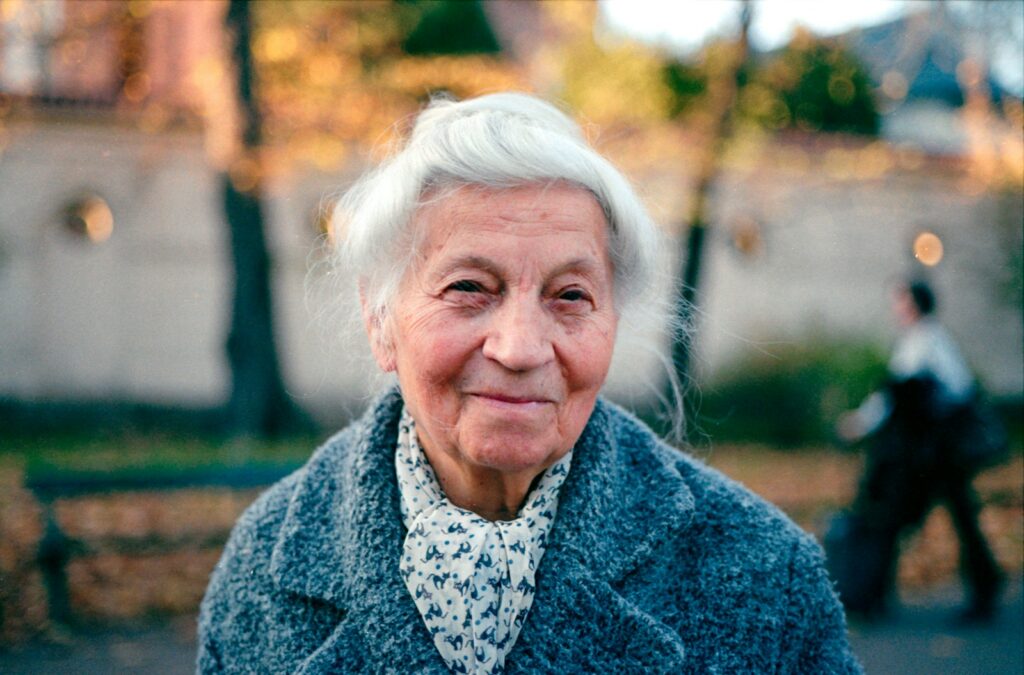 An old woman is walking down the street