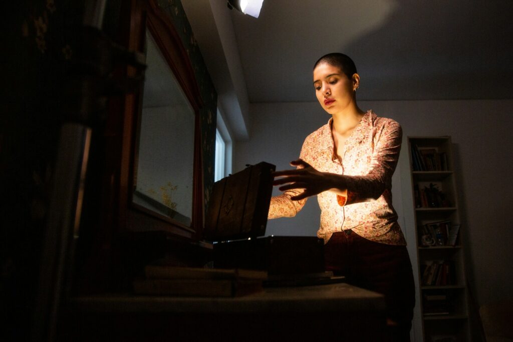 a woman holding a suitcase in a dark room