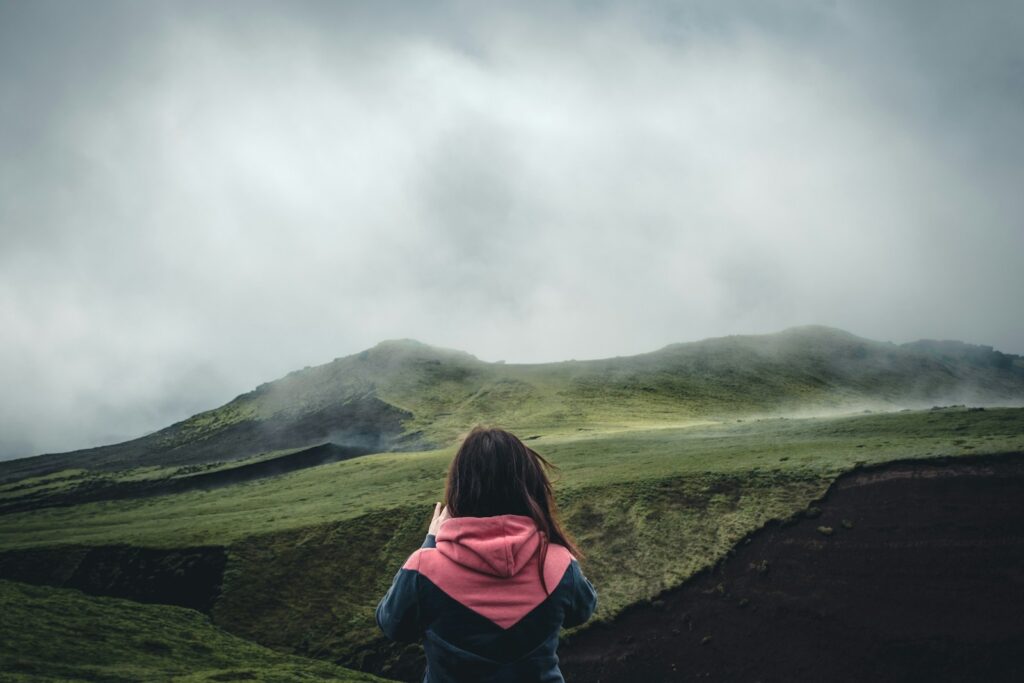 a person sitting on a hill
