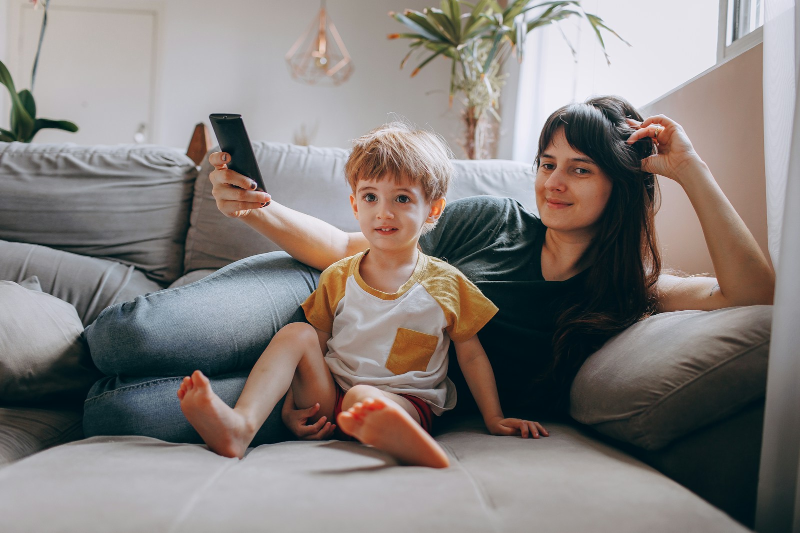 a woman and a child sitting on a couch