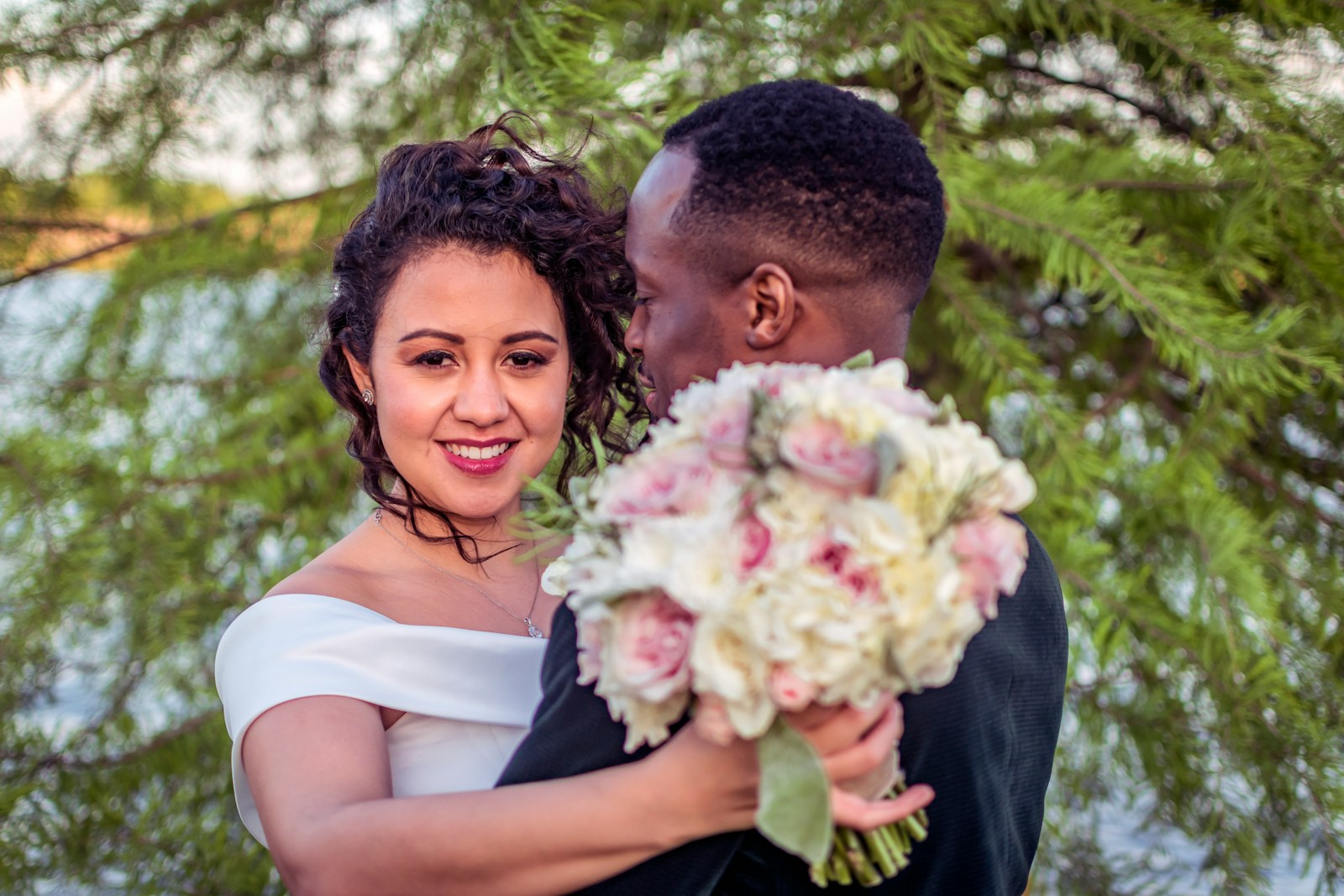 man in black shirt holding white flower bouquet