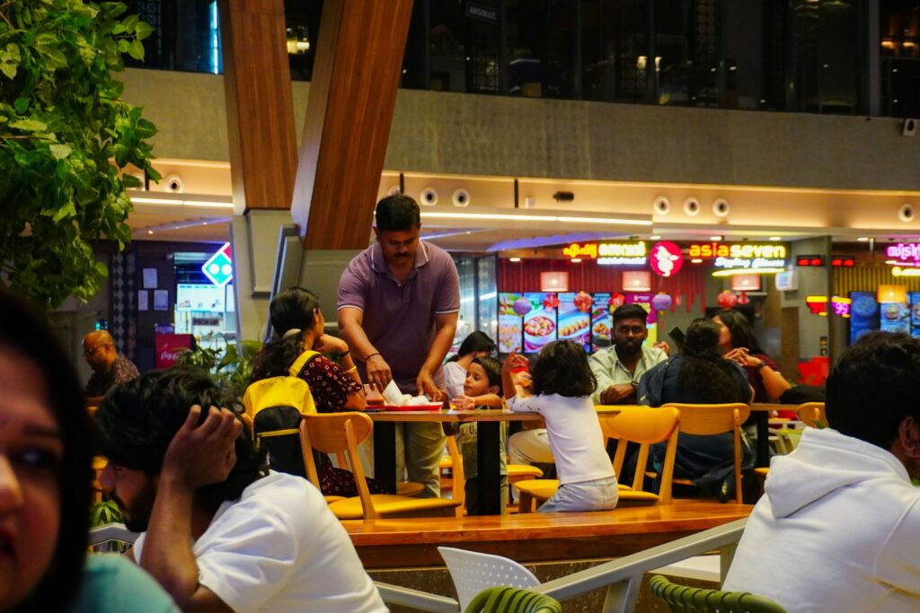 People dining in a busy food court at night