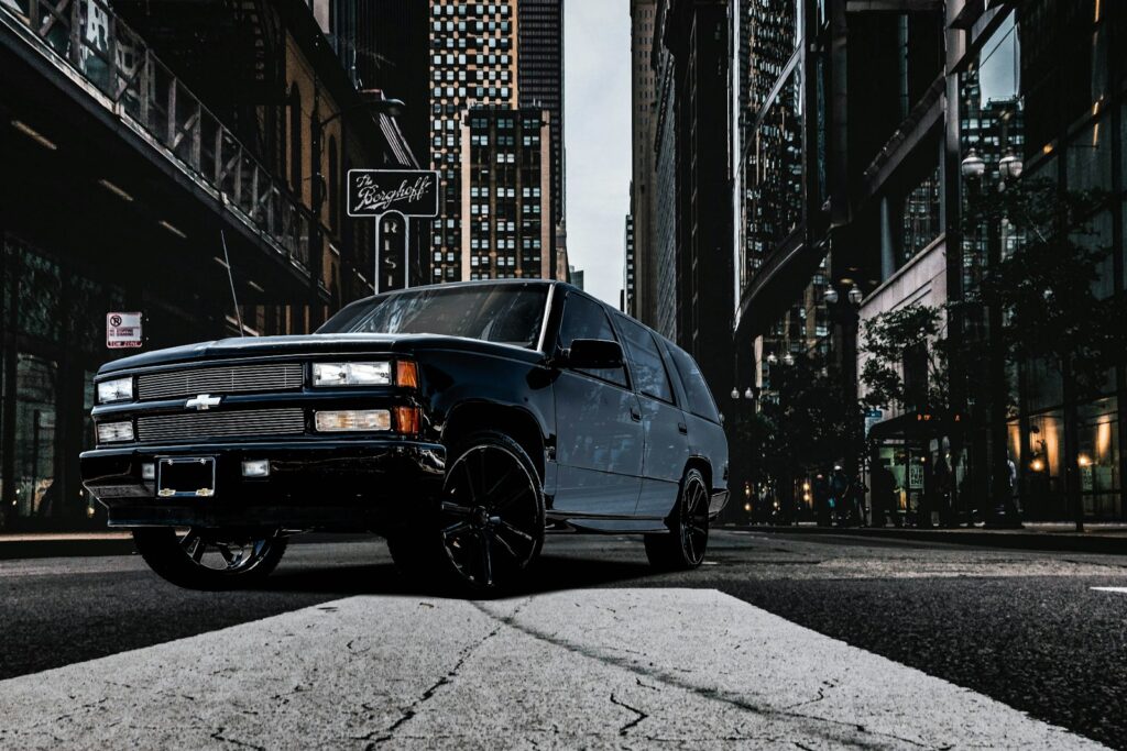 a black truck parked on the side of the road