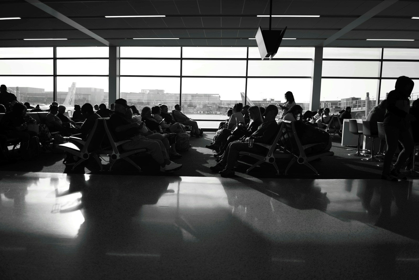a black and white photo of people sitting in chairs