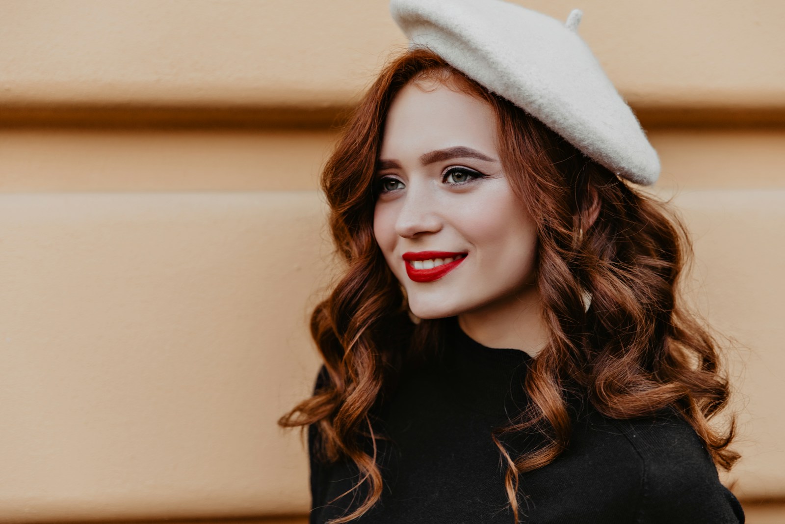 a woman in a black dress and a white hat