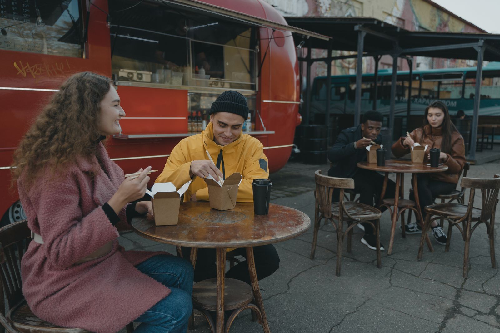 Person Carries An Open Laptop Through A Windy Food Truck Area Like Nothing Bad Could Possibly Happen