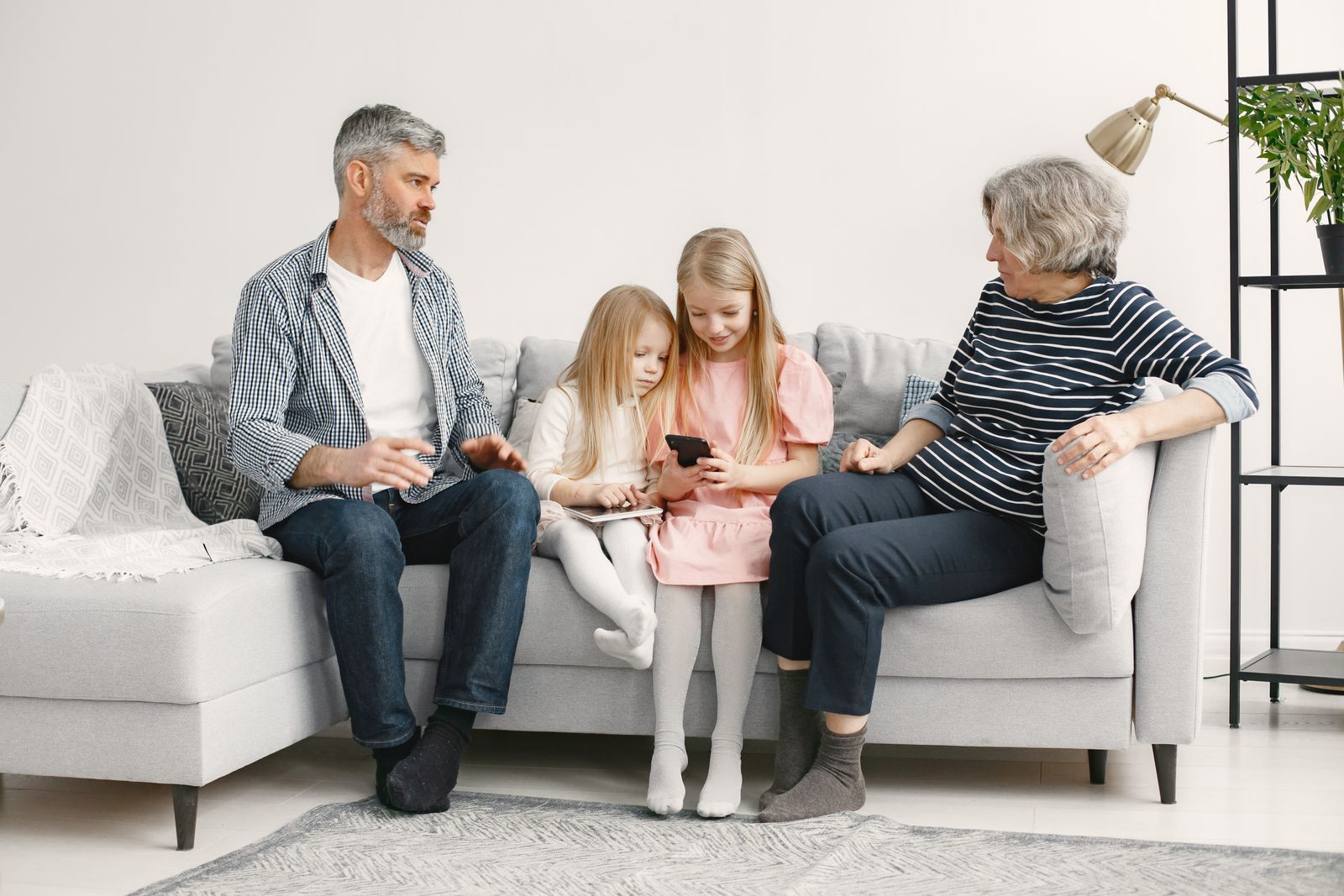 A joyful family enjoys quality time together on a cozy living room couch.