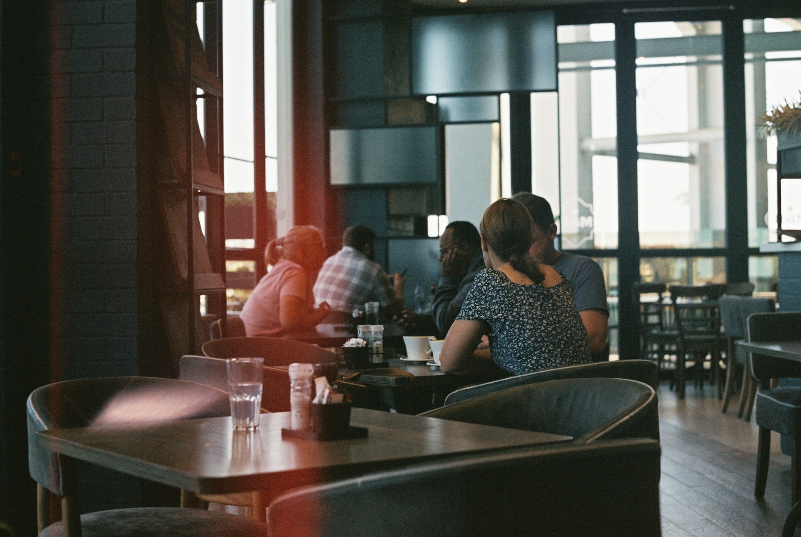 A group of people sitting at a table in a restaurant
