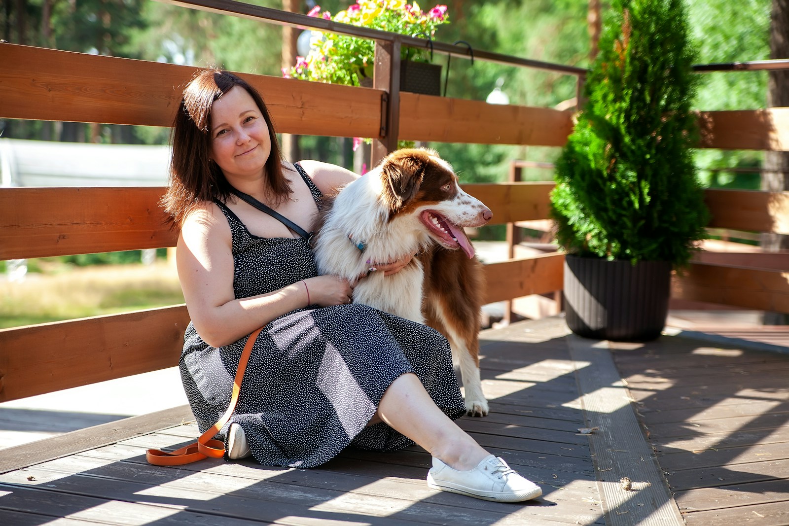 a woman sitting on a bench with a dog